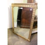 A gilt framed bevel plated wall mirror with decorative leaves