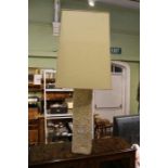 A textured white painted ceramic 1970's table lamp together with parchment shade