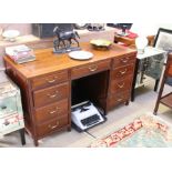 A modern mahogany coloured twin pedestal nine drawer desk