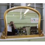 A gilt framed arch top overmantle mirror