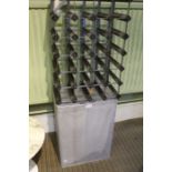 A wire work laundry basket together with a wine rack.