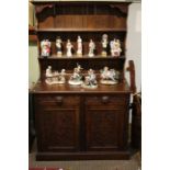 An oak carved dresser, two drawers over two doors.