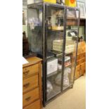 A burnished steel & glass display cabinet with adjustable shelved interior