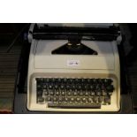 A cased manual typewriter.