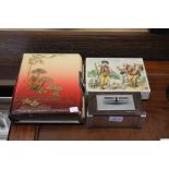 An Oriental design album of 20th century family portrait photographs, together with a boxed multi im