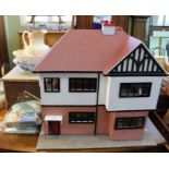 A 1940's dolls house with a quantity of dolls house furniture