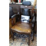 Edwardian barbers chair reclining back and adjustable head rest.