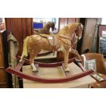 A rocking horse on painted arch rocker