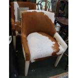 A pair of animal hide covered occasional chairs.