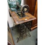 A singer sewing machine on treadle base.