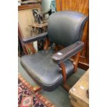 A mid century mahogany swivel office chair.