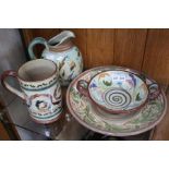 Four pieces of colourfully glazed studio pottery, includes a jug, all bear stylised signature to bas