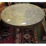 A fold out brass top table.