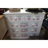 A pine five drawer chest later painted and floral stencilled