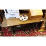 A rectangular oak coffee table with carved legs.