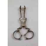 A pair of George III period silver scissor action sugar tongs, makers mark "RM", 38g