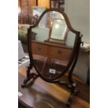 A small shield shaped dressing table top mirror.