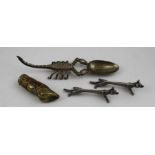 A pair of cast metal fox design knife rests, a hoof design vesta case, and a cast scorpion spoon