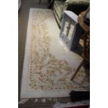 A white ground rug, with red decoration 232 x 322 cm.