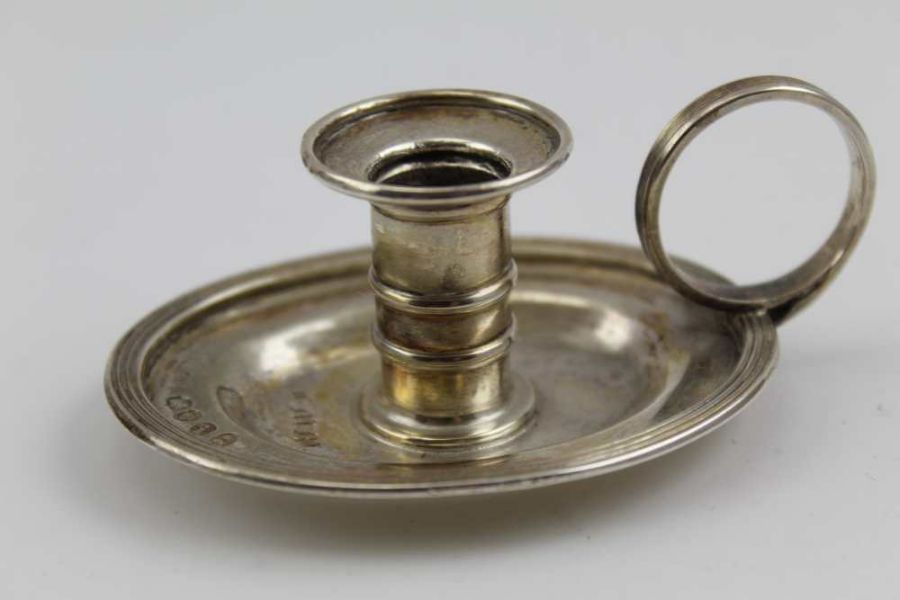 Charles Rawlings, A George IV silver small chamber or taper stick holder, oval base with ring handle