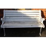 A white painted slatted garden bench with cast metal ends.