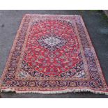 A Persian design red ground rug, 256cm x 146cm