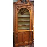 Pine corner cabinet with decorative carving, free standing with barrel back.