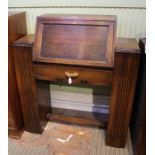 An art deco design oak desk having fall down front over single drawer supported on twin ribbed.