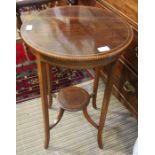 An Edwardian mahogany circle topped table with decorative edging.