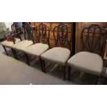 A set of eight dining chairs two carvers with fancy shaped backs with fleur de leys crest.