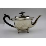 Walker & Hall, A silver teapot, shaped rim, hinged cover, raised on four hoof feet, Sheffield 1914,