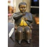 A nineteenth century American made cast metal money bank of a seated bank manager.