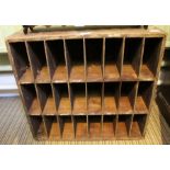 A vintage wooden bank of 24 pigeon holes.