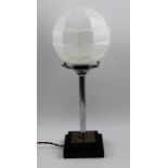 An Art Deco table lamp, chrome stem on an ebonised base, fitted a white opaline shade, overall 46cm