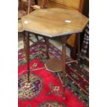 An Edwardian octagonal topped table with satin wood cross banding supported on four lightly turned