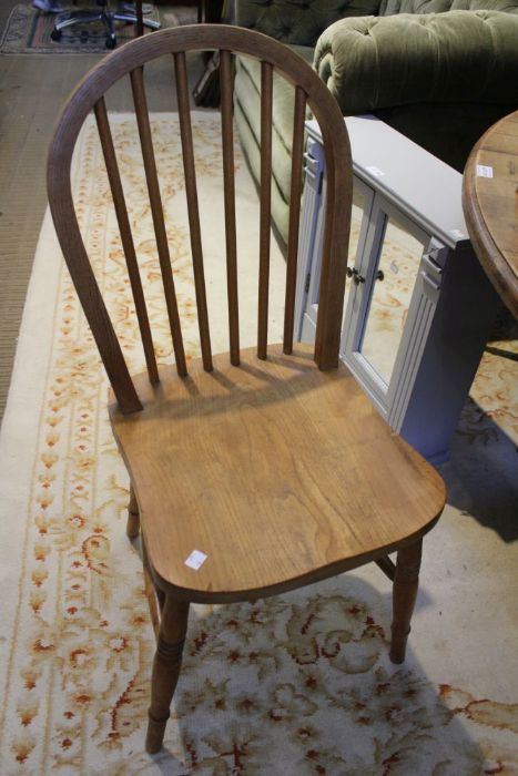 A set of four hoop and stick back chairs