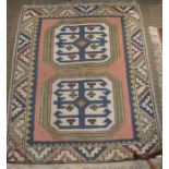 A small woven woolen geometric floor carpet. 102 x 127 cm.