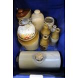 A box containing foot warmers & other stoneware