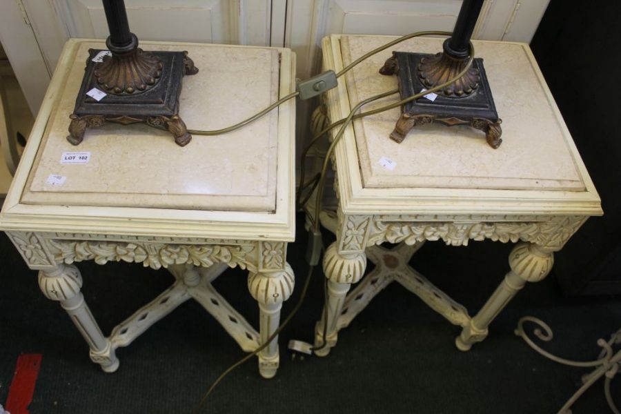 A pair of marble topped side tables