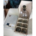 A boxed new small decanter with six shot glasses, by Sussmuth, retailed by Heal's.