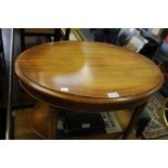 A small yew wood oval two tier reproduction coffee table
