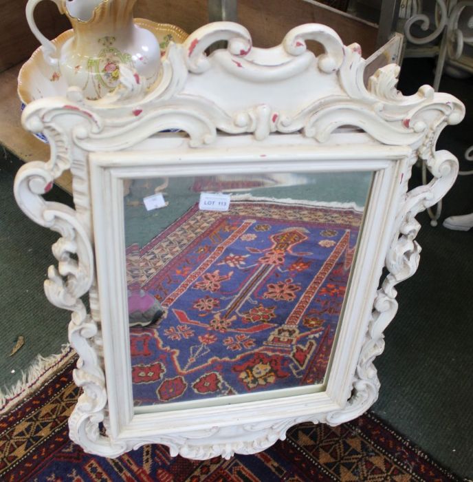 A white painted fancy framed mirror