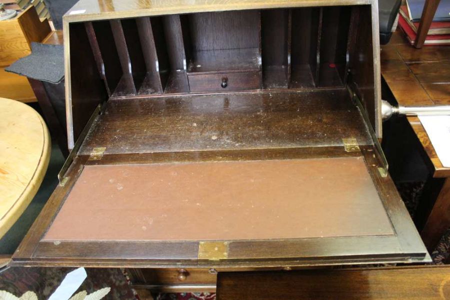 A 20th century oak bureau with three drawer front