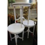 A trio of white painted circular side tables