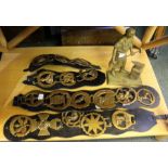 A box of horse brasses and a brass model of a blacksmith.