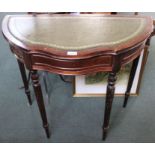 A reproduction leather topped demi-lune side table with single central drawer