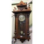 A small sized Vienna wall clock, with pendulum and key. Approx 95 cm high.