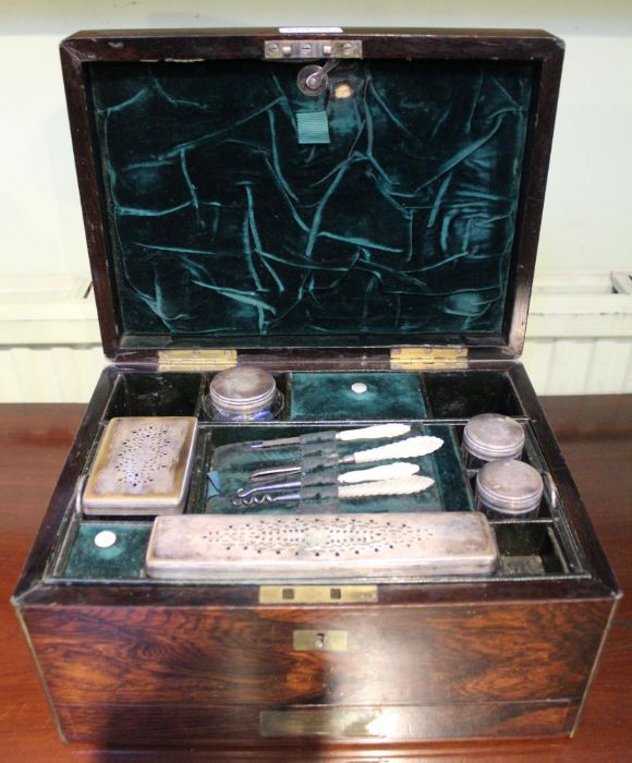 A 19th century brass bound rosewood vanity box with fitted interior retaining some accoutrements