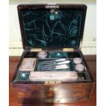 A 19th century brass bound rosewood vanity box with fitted interior retaining some accoutrements