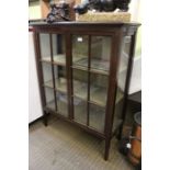 A 20th century mahogany glazed display cabinet having upholstered shelved interior.